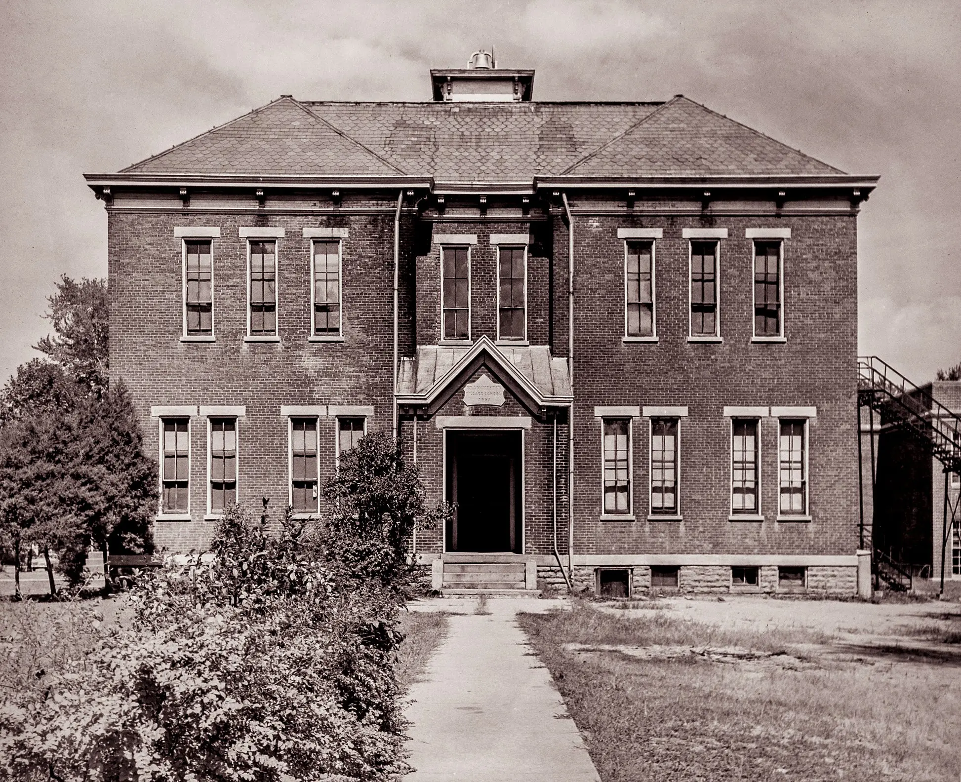 Archival monochrome photograph of early students and teachers